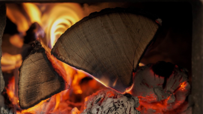 Dry firewood burning in a fireplace